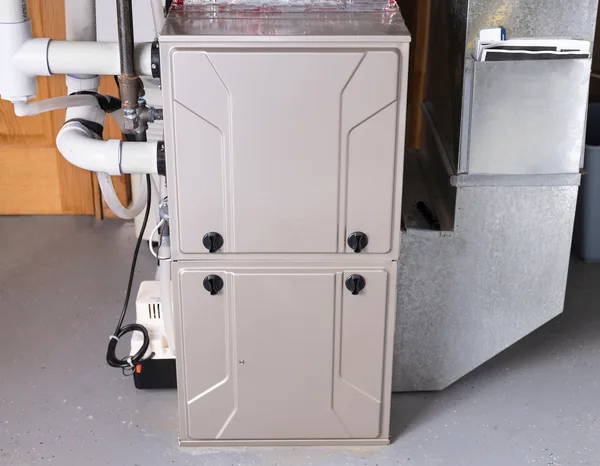 Greers Ferry Heat & Air technician installing a new gas furnace