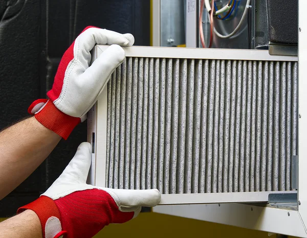 Greers Ferry Heat & Air technician performing a furnace maintenance tune-up