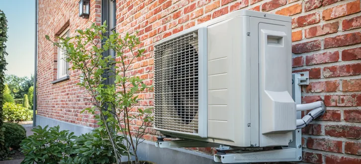 Greers Ferry Heat & Air technician inspecting and diagnosing an outdoor heat pump unit