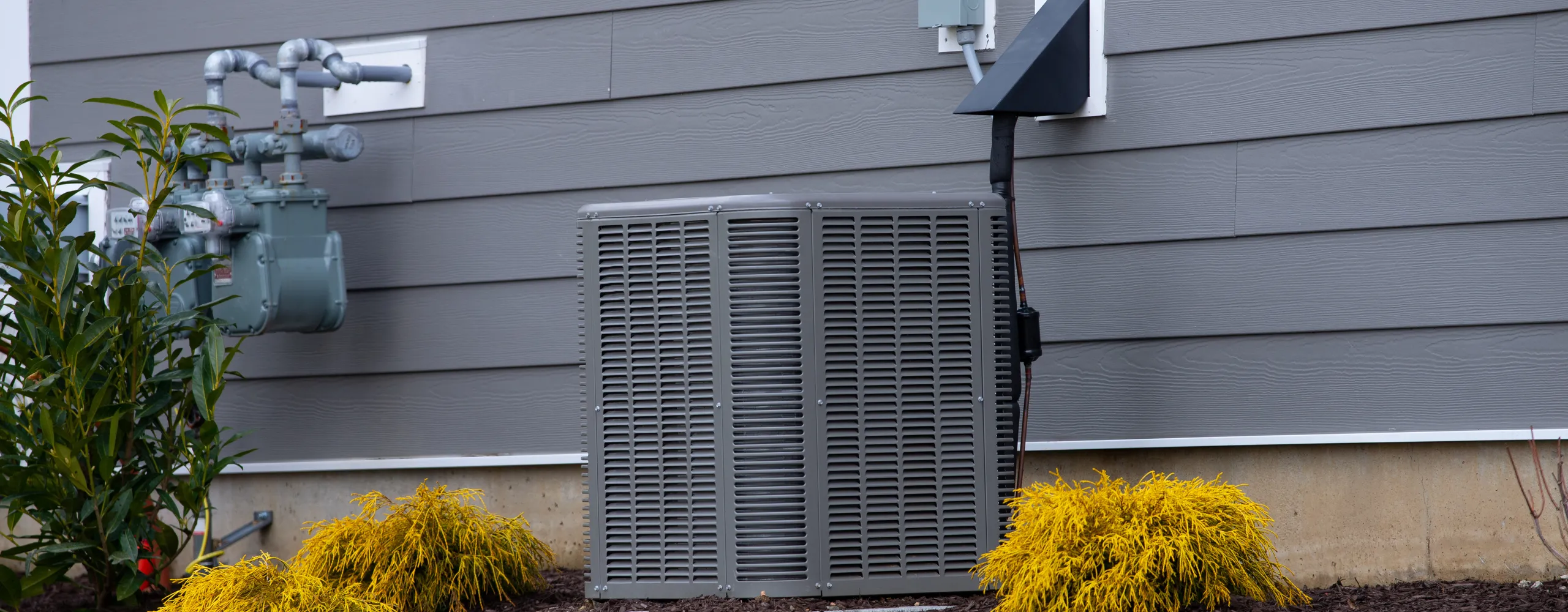 Greers Ferry Heat & Air technician servicing a residential heat pump in Greers Ferry, AR