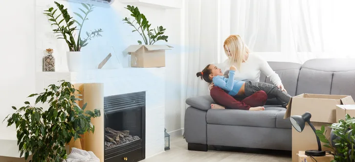 Greers Ferry Heat & Air technician assessing indoor air quality equipment in a home