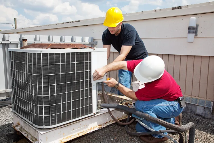 Greers Ferry Heat & Air technicians servicing a commercial rooftop HVAC unit