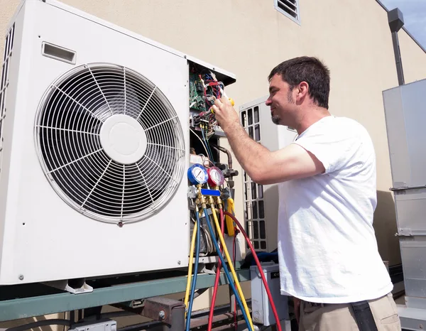 Greers Ferry Heat & Air technician performing seasonal maintenance on a ductless mini-split unit