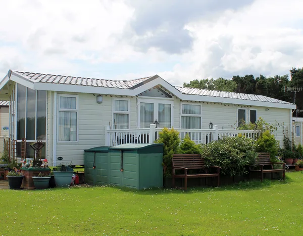 Greers Ferry Heat & Air technician servicing a heating and cooling system on a manufactured home