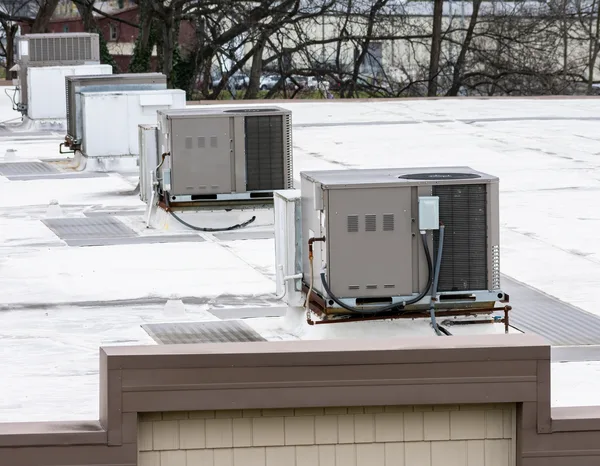 Greers Ferry Heat & Air technician installing a new package unit at a home