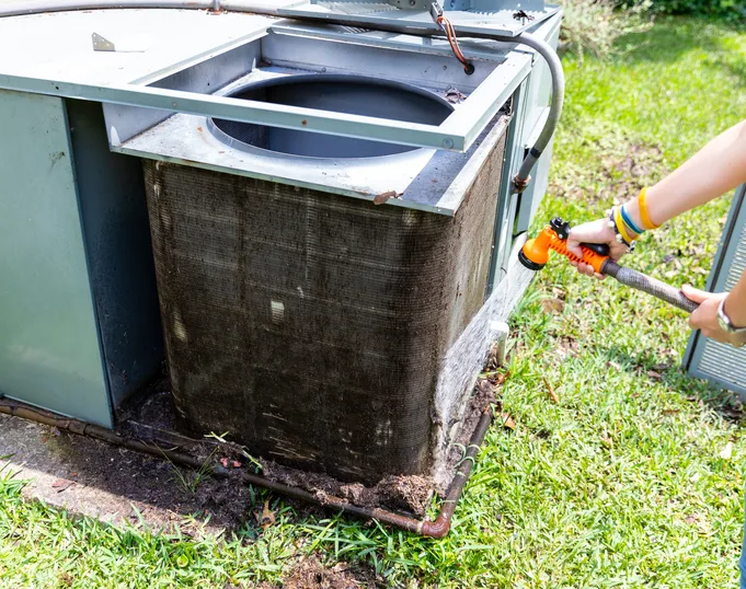 Residential packaged HVAC unit installed beside a central Arkansas home