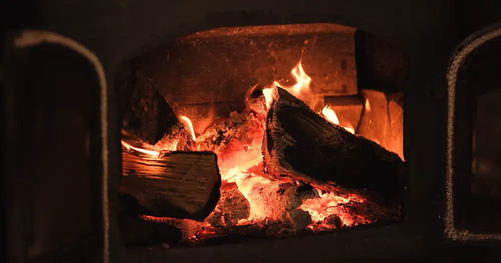 A warm, cozy fire in a fireplace at Christmas time.