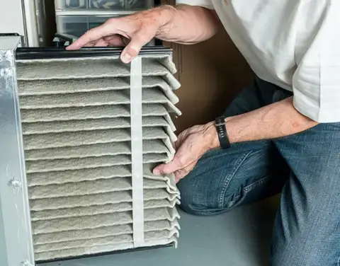 Changing a very dirty air filter in this customer's HVAC unit.