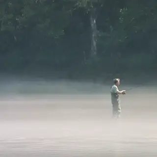 A man patiently fishing out in White River.
