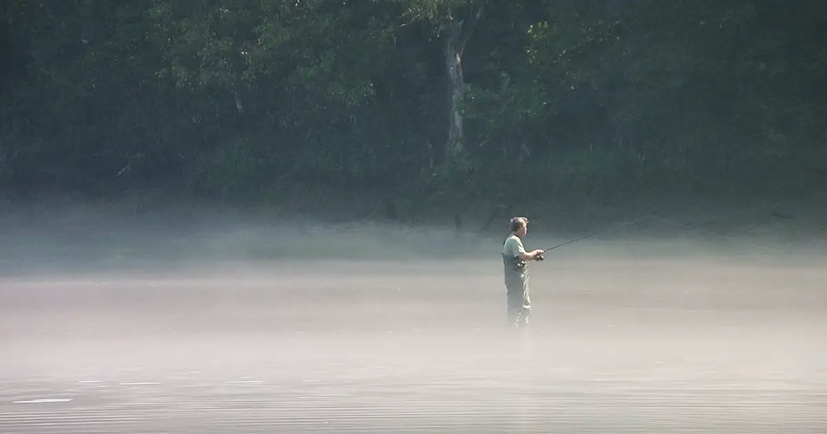 A man patiently fishing out in White River.